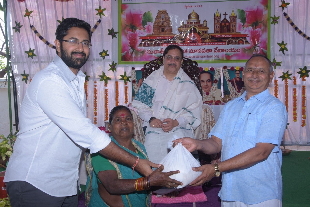 Sri M.Bharat (Geetham Institutes Chairman, Vishakapatnam and Sri S.Veerabhadra Rao , Editor of Visakha Samacharam distributing saree and rice to poor women  on the occasion of 18thAnniversary of Bheemili Ashram