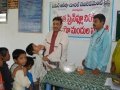 Dr. Umar Alisha, Chairman UARDT, giving Swine Flu preventive medicine to a child at Pithapuram on 27-Aug-2009